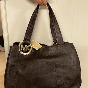 Michael Kors brown bag, new with tags. Color: Dark brown.